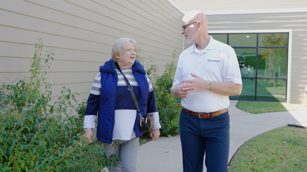 A staff worker at BirchPointe speaking with a family member of a patient about resources in skilled nursing
