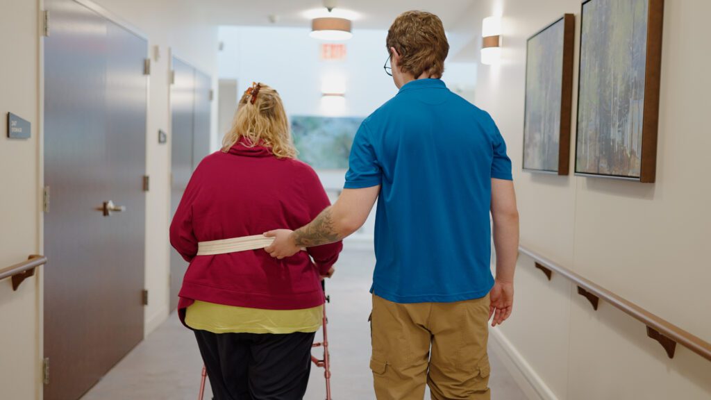 A nurse assisting a short term rehab patient with physical therapy